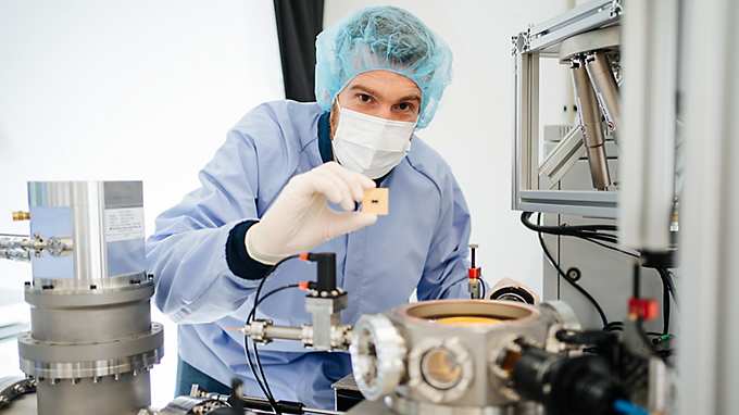 Man holds up a quantum chip