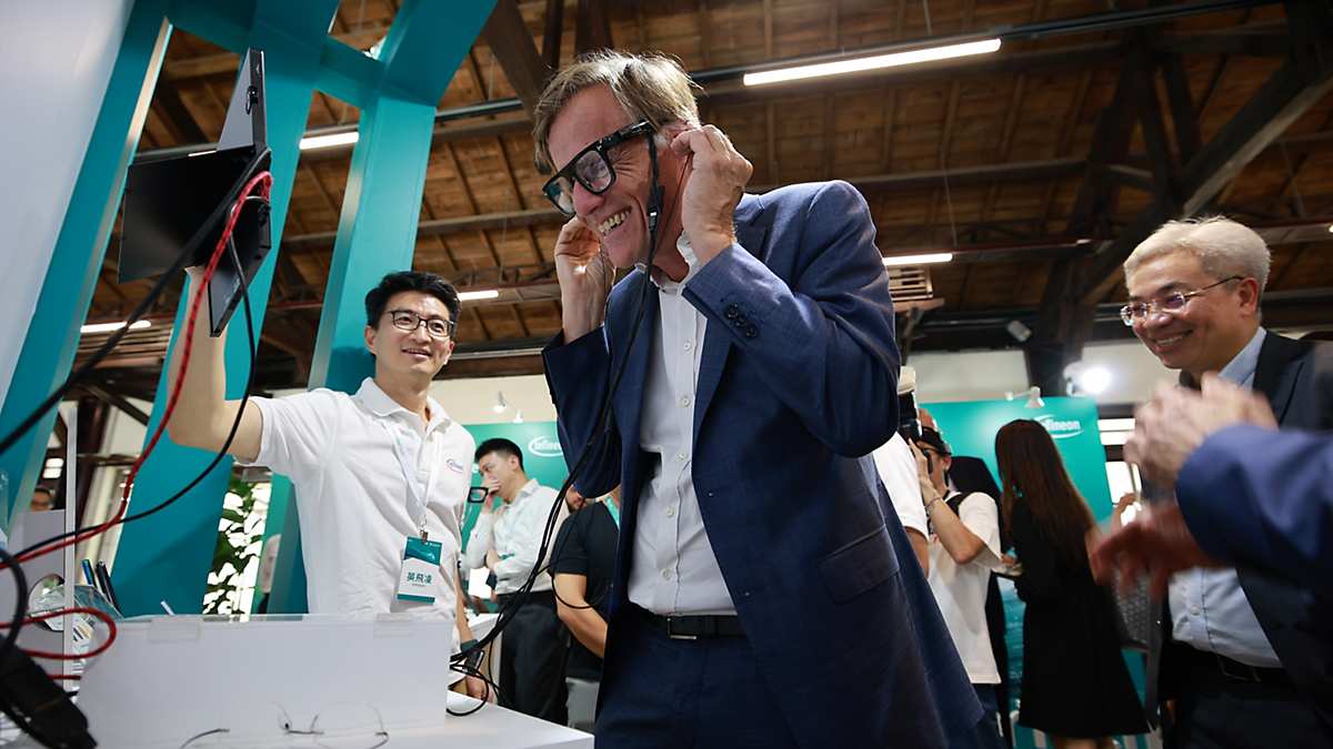 CEO interacting with a stand