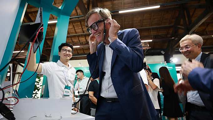 CEO interacting with a stand