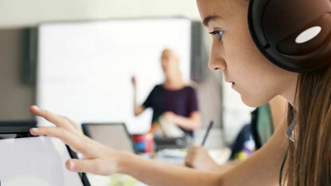 Students studying in front tablet