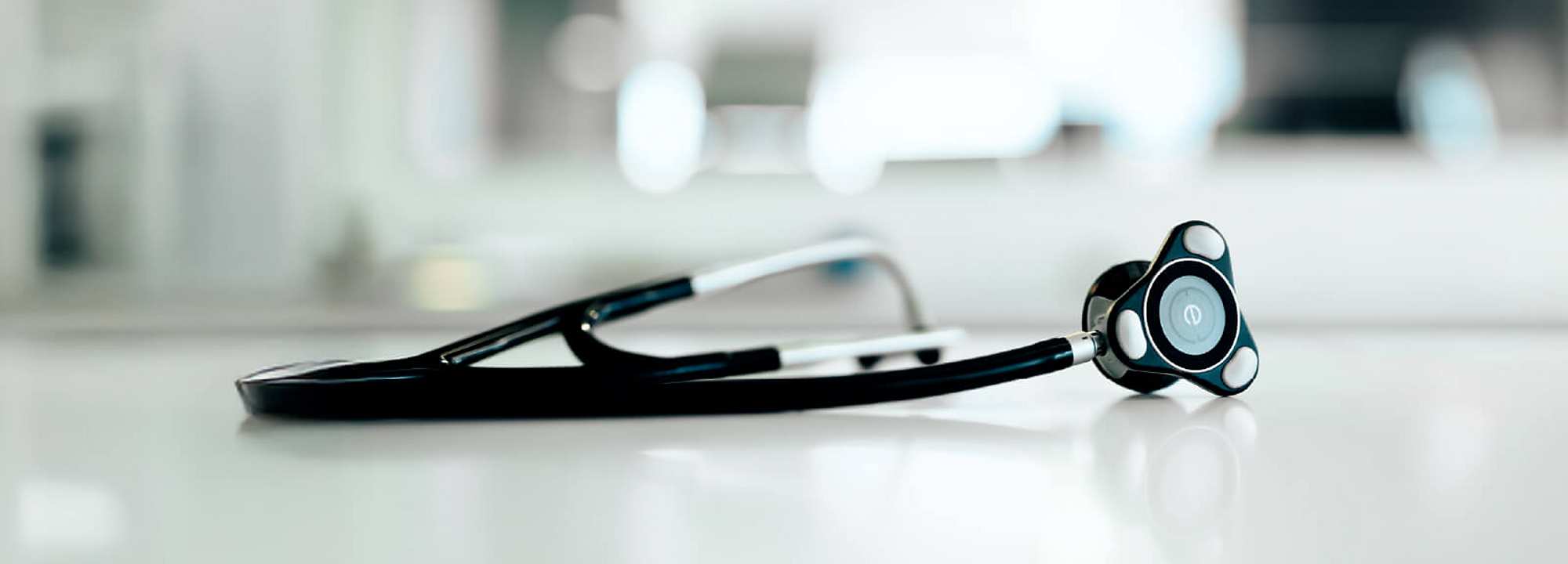 Black digital stethoscope from Eko Health on white surface – modern medical device in professional clinical setting