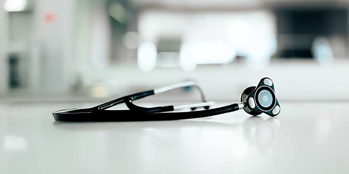 Black digital stethoscope from Eko Health on white surface – modern medical device in professional clinical setting