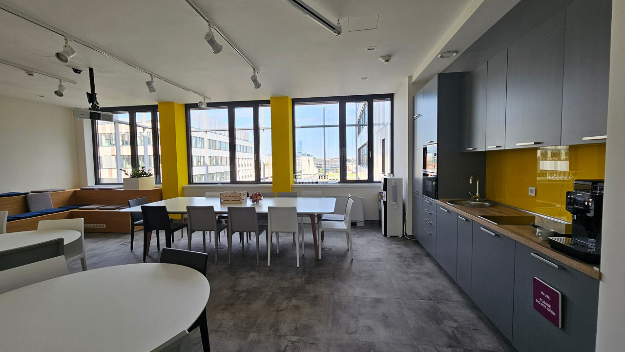 A welcoming social area and kitchen stocked with fresh fruit and a coffee machine, perfect for recharging and connecting with colleagues.