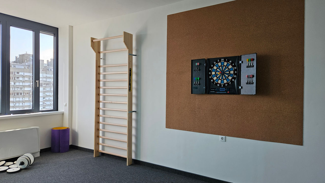 Our relaxation room offers a fun and inviting space to take a break, socialize, and enjoy games like darts and video games.