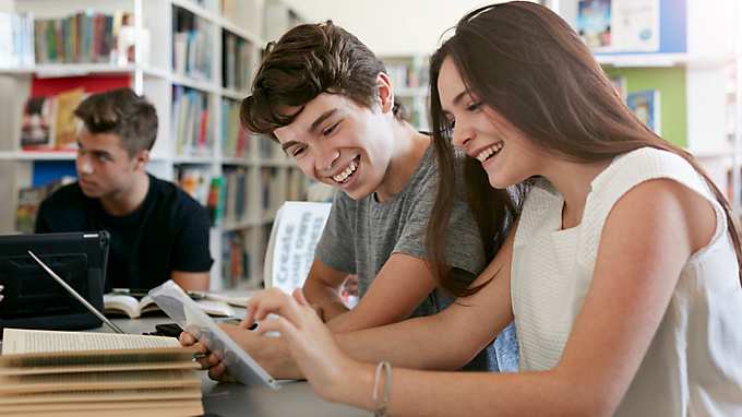 Students studying in front tablet