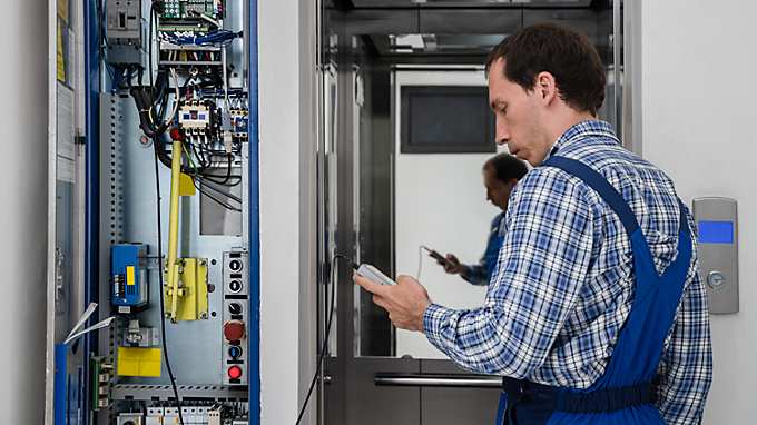 Technician repairing an elevator