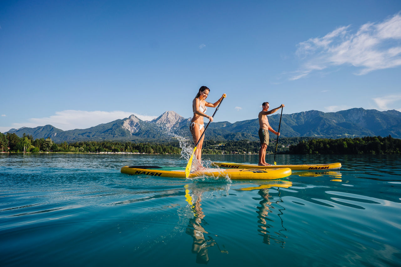 two people doing paddle in a Lake